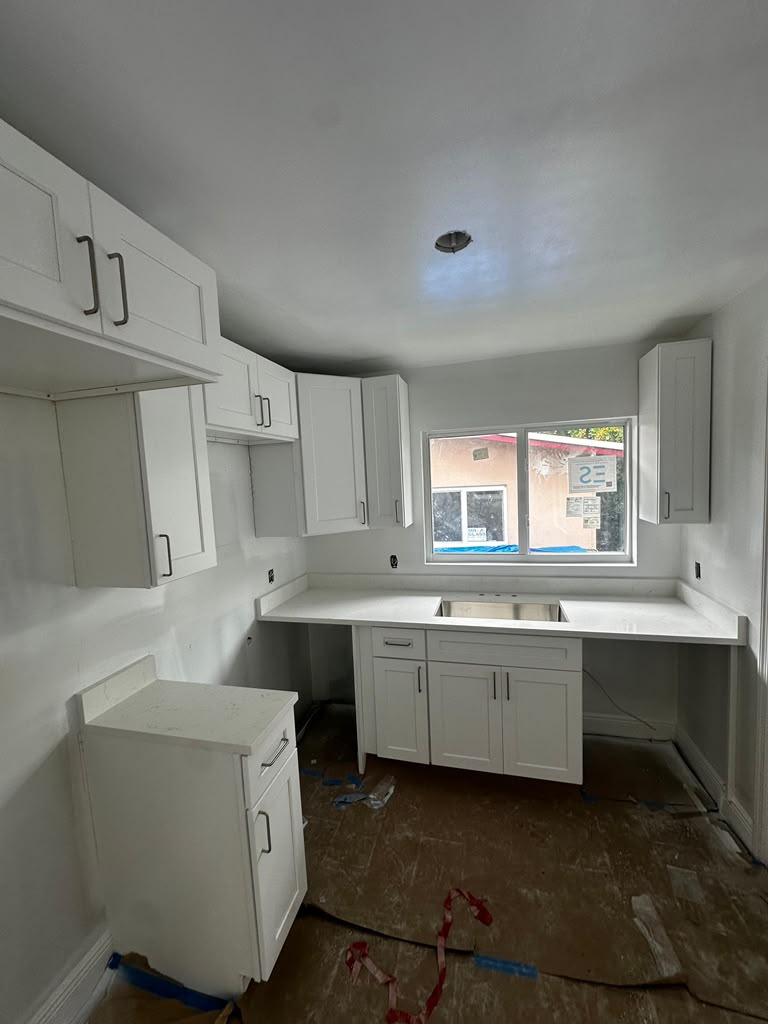 White shaker kitchen with white countertops