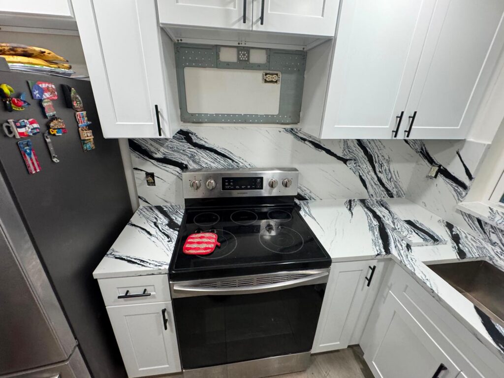 Full-height veined backsplash behind the range