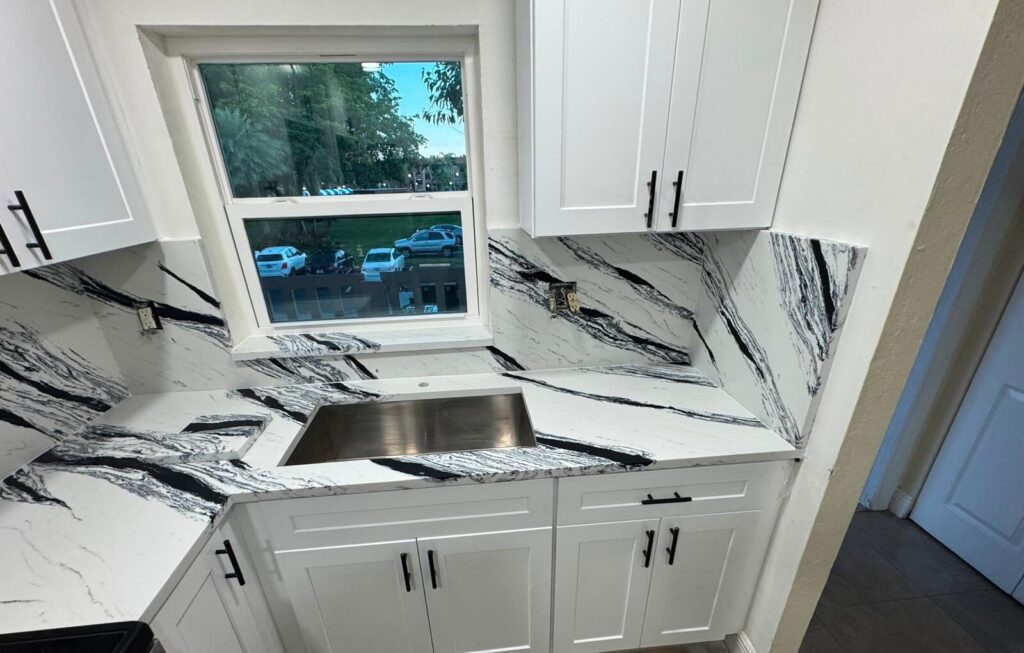 White shaker kitchen with black-and-white veined countertops